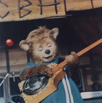 Beary Barrington from The Country Bears playing the One Strang Thang on stage.