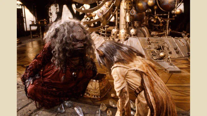 Aughra and Jen from The Dark Crystal looking at crystal shards on the floor of Aughra’s observatory.