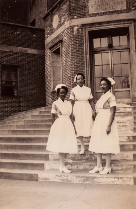 Photo of three nurses on the steps of the Lincoln School for Nurses, Bronx, New York, circa 1930