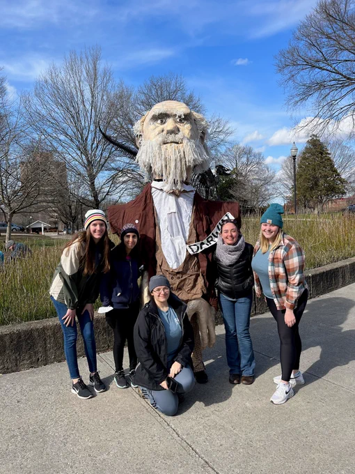 A 10 foot tall puppet of Charles Darwin made out of paper mache. Surrounding it are Dr. Derryberry and four EEB students.