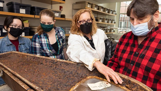 Megan Perry discusses a coffin recovered from the recovered from the Rhem family ancestral tomb in New Bern?s Cedar Grove cemetery, with family member Michael Miller, right, and anthropology graduate students Bridget Cone and Ceara Nicholson.