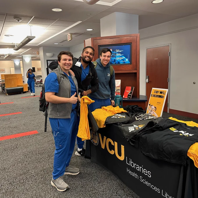 Three students smile with tshirts 