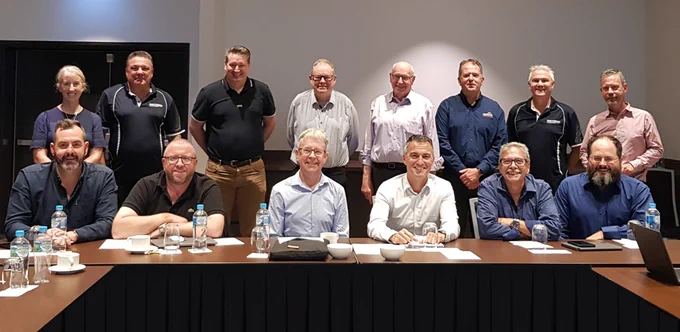 Group of 14 people in business attire at the 2023 ARCIA Planning Day in a conference room in Brisbane.