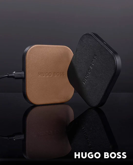 HUGO BOSS | WIRELESS CHARGER | ICONIC
A new version of our wireless charger is available, celebrating the iconic HUGO BOSS rebranding with matt black metal accents and luxurious pebble grain PU finishings. This camel and black version is a pure reflection of our new iconic HUGO BOSS collection: graphical, modern and simple. This Hugo Boss wireless charger is not only very practical, but also an eye-catcher on your desk. From now on, you won't need a cable to charge your smartphone. Simply place the device on top and, voilà? it starts charging by itself. Compatible to all Q1 devices. This square design charger has an aluminum finish with elegant round corners and a subtle Hugo Boss logo. The charging pad is made of fabric. The compact size 84 x 84 x 9.5 mm makes it easy to take the charger with you. 

https://b2bgiftsshop.com/products/wireless-charger-iconic-camel

#hugoboss #hugobosswireless #iconic #wirelesscharger #androidphone #iphone #Q1 #desktopitems #typec #travel #holidays 
