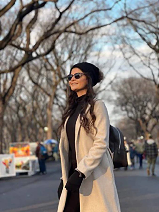 person poses for photo outside