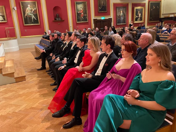 Academy Opera student sitting on the front row of the Duke's Hall waiting to perform. 