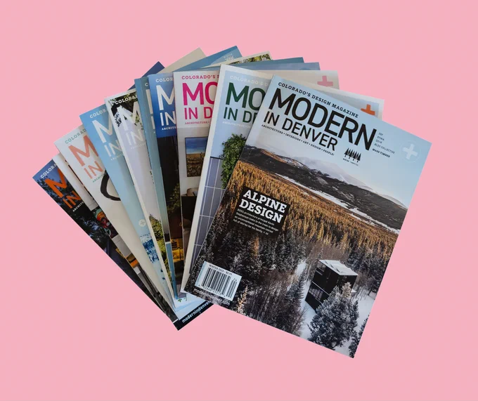 stack of magazines on pink background