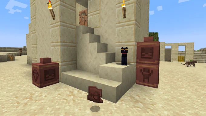 Pots and a pottery shard in a desert setting
