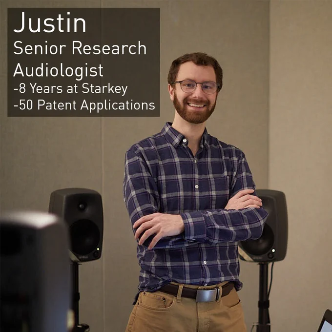 Justin, a Senior Research Audiologist, smiles from in the lab. He has been with Starkey for 8 years and has 50 patent applications.