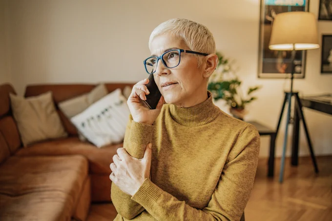 A woman talking on the phone to a health care professional.
