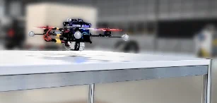 Quadrotor overflying a table in close proximity to the plane. Our approach can model the aerodynamic effects in close proximity to the ground, substantially limiting the horizontal tracking error.