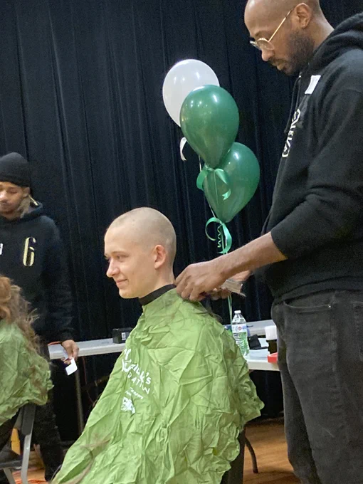 A student shaves to support St. Baldrick's