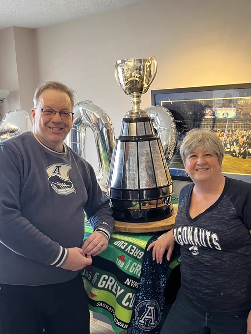Me and Mrs. Dictator with the Grey Cup on our piano