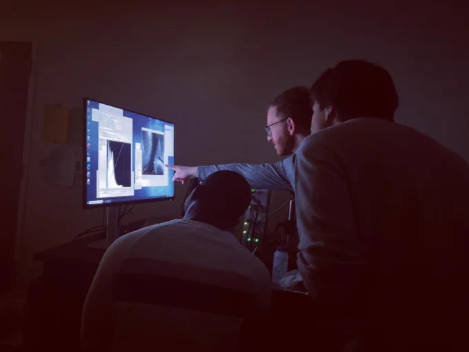 Scientists looking at images during the installation of the ASI ct-dSPIM lightsheet microscope at the UNC Neuroscience Microscopy Core.
