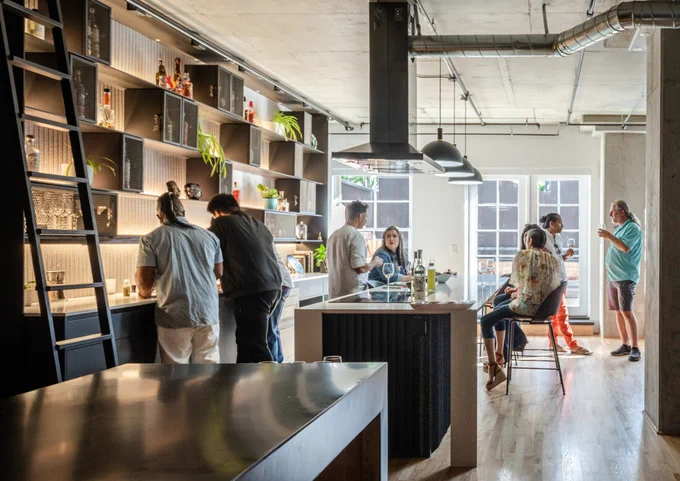 modern kitchen with people gathered standing and sitting