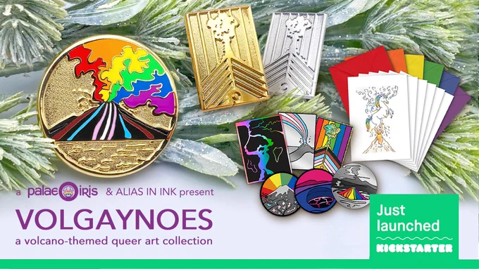 A close-up photograph of pins, stickers, and greeting cards featuring the art of volcanoes and magma flows around the word through colours of the Progress Pride flags. The following text is on the graphics: a Palaeoiris and Alias in ink present Volgaynoes, a volcano-themed queer art collection. A green strip is at the bottom with "Just launched on Kickstarter" logo on it. 