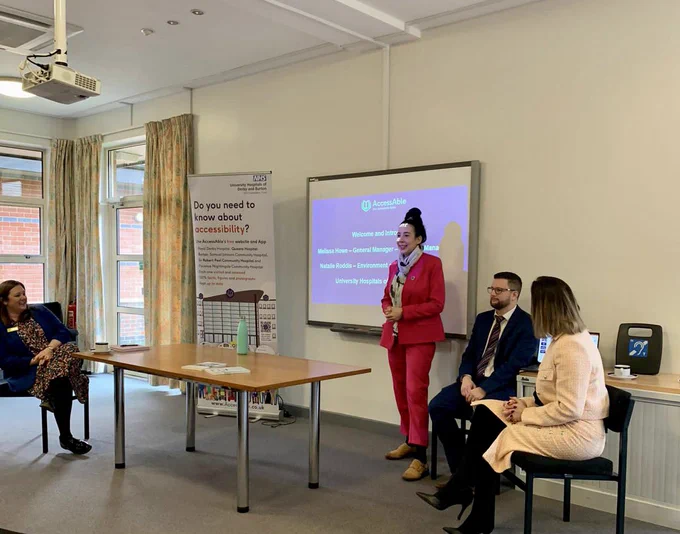 Speeches under way at the launch event. Natalie and Melissa from the Trust and Anna and Dean from AccessAble are in the photos. Natalie speaks in front of a screen while the others listen.