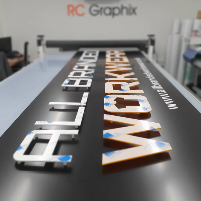 View of tray sign assembled in workshop with the CNC perspex All Branded Workwear logo.