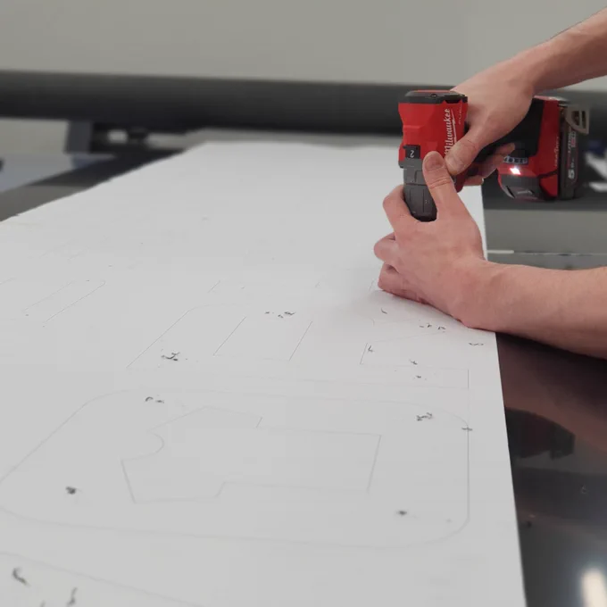 Drilling the tray ready for the CNC lettering using a template.