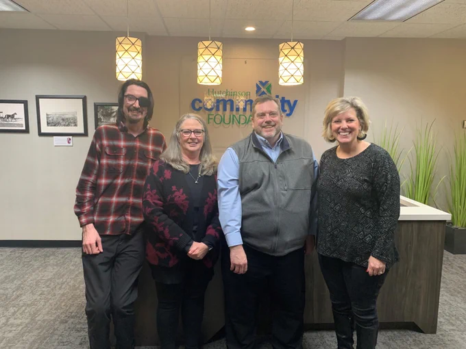 A photo of, from left, StartUp Hutch Program Administrator Christopher Acker, Hutch CF COO Dell Marie Shanahan Swearer, South Central Kansas Economic Development District Executive Director Mark Howell, and Hutch CF President & CEO Aubrey Abbott Patterson posing in the Hutch CF lobby. 