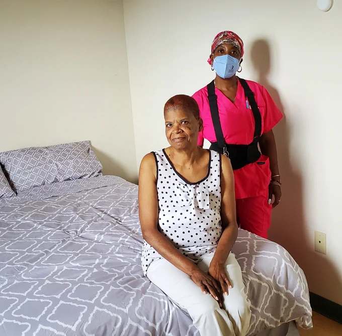 Woman receiving help from professional caregiver.