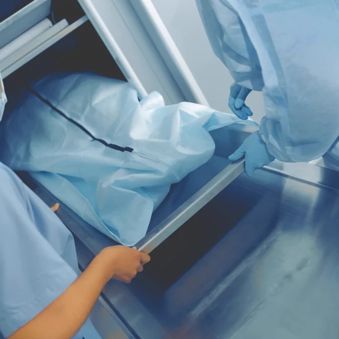 Body bag being removed from a store