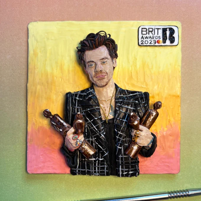 An image of a piece of clay art work where Harry Styles holding his 4 BRIT Awards