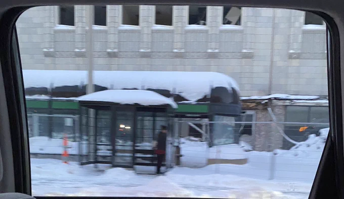 Snow piled up on top of a bus shelter by the road. The picture is blurry because I took it while in the (warm) car on the ride to dinner. My kids will be so impressed by the amount of snow around and on top of the shelter.