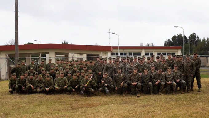U.S. Marines with maritime raid force, 31st Marine Expeditionary Unit, and members of the reconnaissance battalion, Amphibious Rapid Deployment Brigade, pose for a photo during the opening ceremony of their subject matter expert exchange for Iron Fist 23 on Camp Hansen, Okinawa, Japan, Feb. 14, 2023. The USMC and ARDB regularly come together for training evolutions and celebrate a long-standing history of cooperation and partnership. Iron Fist is an annual bilateral exercise designed to increase interoperability and strengthen the relationships between the U.S. Marine Corps, the U.S. Navy, the Japan Ground Self-Defense Force, and the Japan Maritime Self-Defense Force. (U.S. Marine Corps Photo by Cpl. Christopher W. England)

