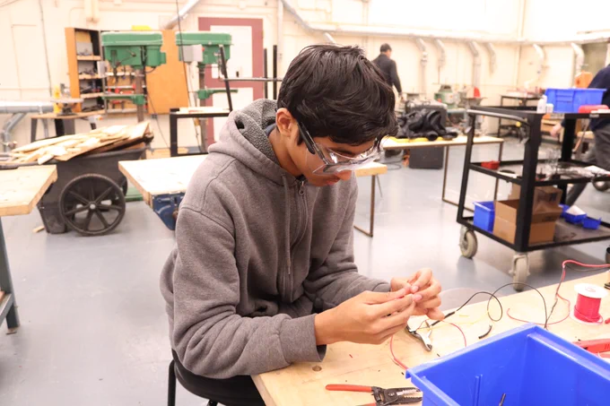 A student soldering.