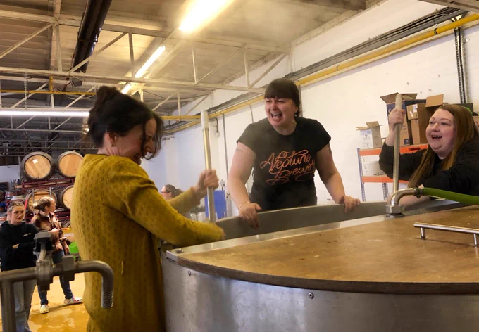 Julie, Charlotte and Jo sharing a laugh over the mash tun