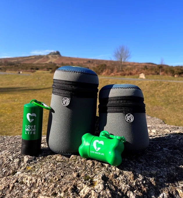 Love Moor Life dicky bags and poo bag holders on a rock with Haytor in the background. 