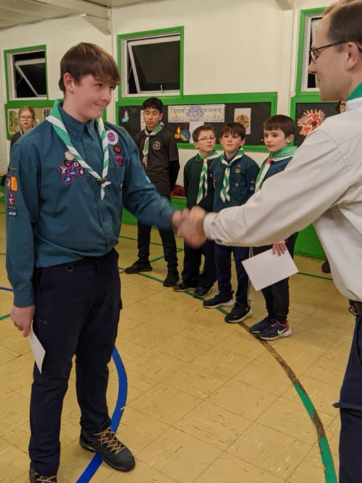 A Scout shaking the hand of a leader