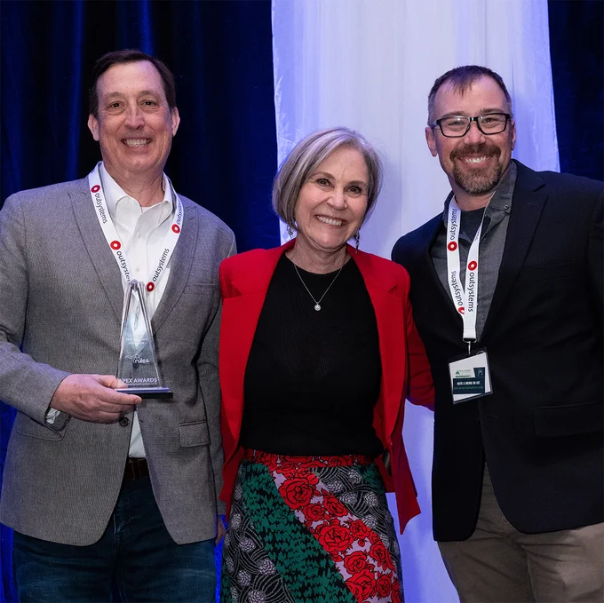 Trent R. Hein (left) and Dan Mackin (right) accept the Emerging Tech Company of the Year Award from Frannie Matthews at the 2023 CTA Tech Summit   APEX Awards.