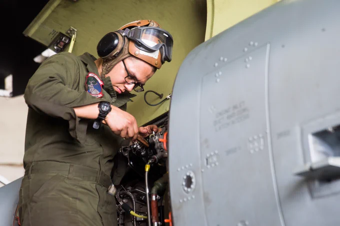 An H-1 mechanic with Marine Medium Tiltrotor Squadron 166 Reinforced, 13th Marine Expeditionary Unit (MEU), removes corrosion on an AH-1Z Viper aboard the San Antonio-class amphibious transport dock USS Anchorage (LPD 23). 