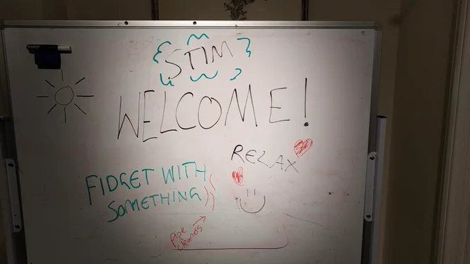 White board saying Welcome Stim Relax Fidget With Something