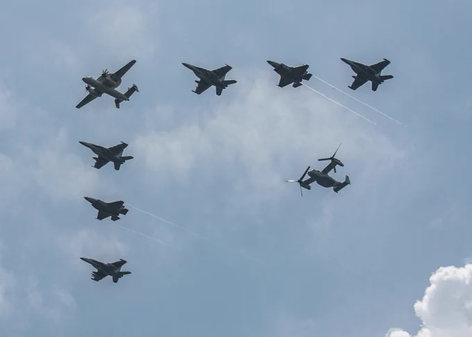 Aircraft from Nimitz Carrier Strike Group (NIMCSG) and Makin Island Amphibious Ready Group (MKI ARG), with embarked 13th Marine Expeditionary Unit (MEU) fly in formation over the aircraft carrier USS Nimitz (CVN 68). NIMCSG, MKI ARG and 13th MEU are conducting combined expeditionary strike force (ESF) operations, demonstrating unique high-end war fighting capability, maritime superiority, power projection and readiness. Operations include integrated training designed to advance interoperability between the two groups while simultaneously demonstrating the U.S. commitment to our alliances and partnerships in the Indo-Pacific region. Nimitz is in U.S. 7th Fleet conducting routine operations. 7th Fleet is the U.S. Navy's largest forward-deployed numbered fleet, and routinely interacts and operates with Allies and partners in preserving a free and open Indo-Pacific region. (U.S. Navy photo by Mass Communication Specialist 3rd Class Joseph Calabrese)