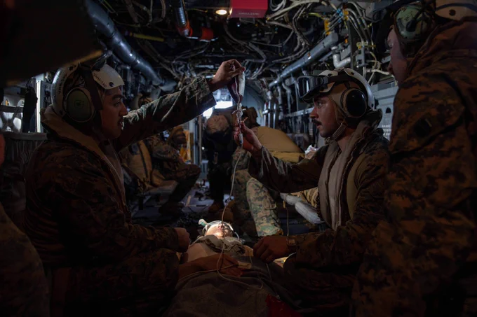Hospital Corpsman 3rd Class Josh Mosqueda, assigned to Marine Medium Tiltrotor Squadron (VMM) 362 (Rein.), 13th Marine Expeditionary Unit (MEU), left, and 3rd Class Guillermo Salguero, assigned to Marine Fighter Attack Squadron (VMFA) 122, 13th MEU, hangs a blood bag during casualty response training in an MV-22 Osprey, assigned to VMM 362, 13th MEU, during Expeditionary Strike Force (ESF) operations with the Nimitz Carrier Strike Group (NIMCSG), Feb. 15, 2023 in the South China Sea. Nimitz Carrier Strike Group (NIMCSG) and amphibious assault ship USS Makin Island (LHD 8) with embarked 13th Marine Expeditionary Unit are conducting joint expeditionary strike force (ESF) operations, representing unique high-end warfighting capabilities, maritime superiority, and power projection, demonstrating the U.S. commitment to our allies and partners in the Indo-Pacific region. (U.S. Navy photo by Mass Communication Specialist 2nd Class Nadia Lund)