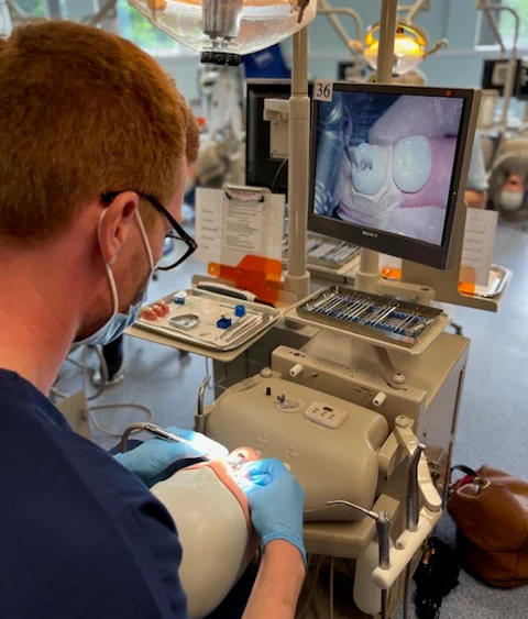Image of a dentist training on a practice implement.