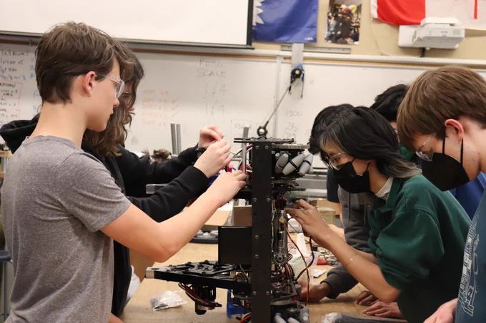Many students wiring up the competition robot.