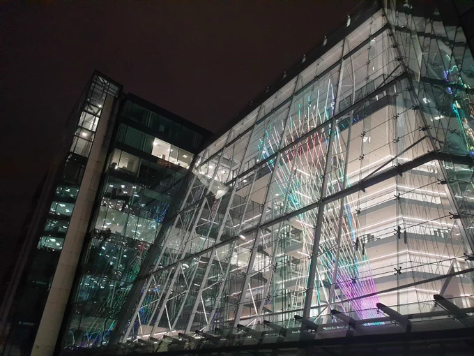 glass skyscraper with neon light installation