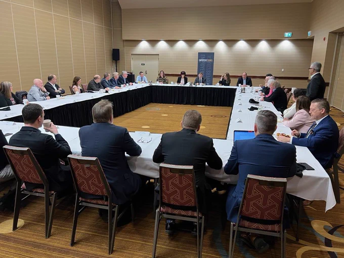 Photo of the Premier and Newfoundland and Labrador Employers’ Council conversing as they sit around a large table.