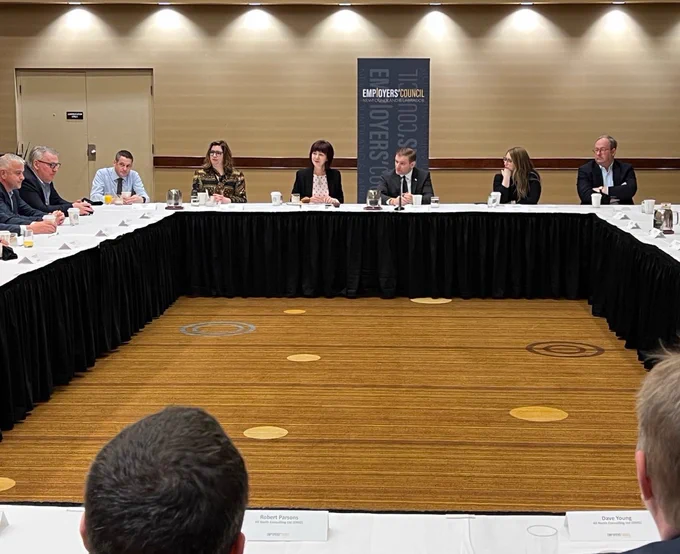 Photo of the Premier and Newfoundland and Labrador Employers’ Council conversing as they sit around a large table.