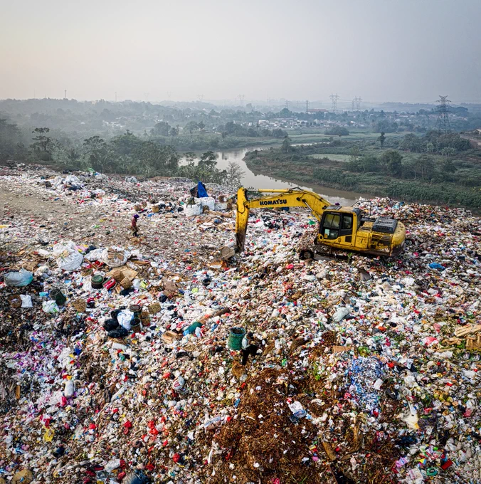 A digger working on a landfill site