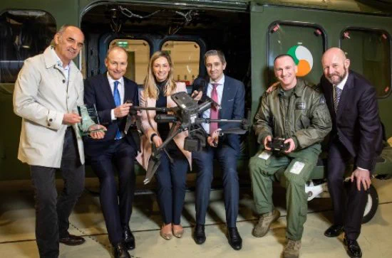 group photo includes Simon Harris, Micheal Martin, Philip Nolan and other CoPilot AI team members holding a drone.