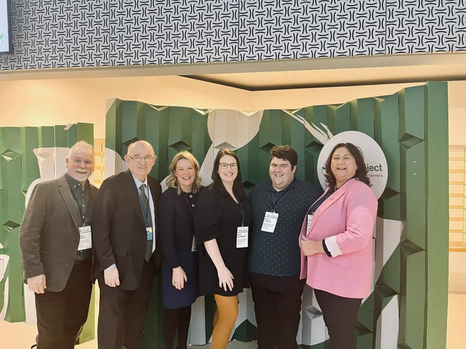 Get Craddock CEUD 
Ambassador Austria 
Anna Cunniffe 
Sarah Boland 
Patrick Fitzgerald 
Minister Anne Rabbitte 
In front of the Zero Banner