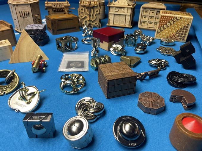 Large collection of various puzzles. Includes many metal puzzles, puzzle boxes, wooden puzzles.