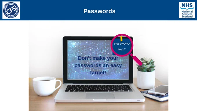 A laptop on a desk. The laptop screen has the words 'Don't make your passwords an easy target' and a magnifying glass highlighting the words 'Password: Dog123'