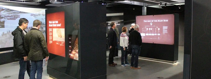 People standing in a well lit museum space.