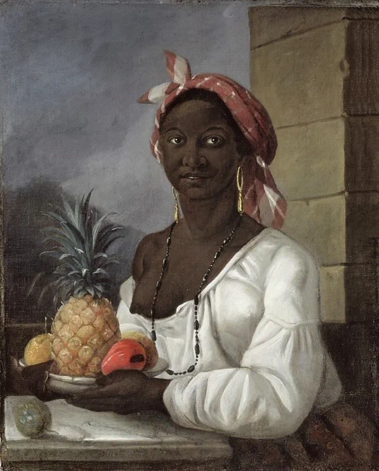 Portrait of a woman holding a plate of fruit wearing a loose white blouse and a red and white patterned headscarf. She has on a long black beaded necklace and is standing before  a window. 